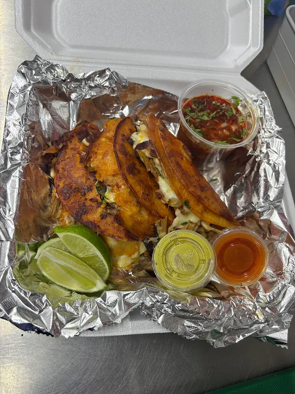 Quesabirrias with consom&eacute;, lime, onion, cilantro, and salsa
